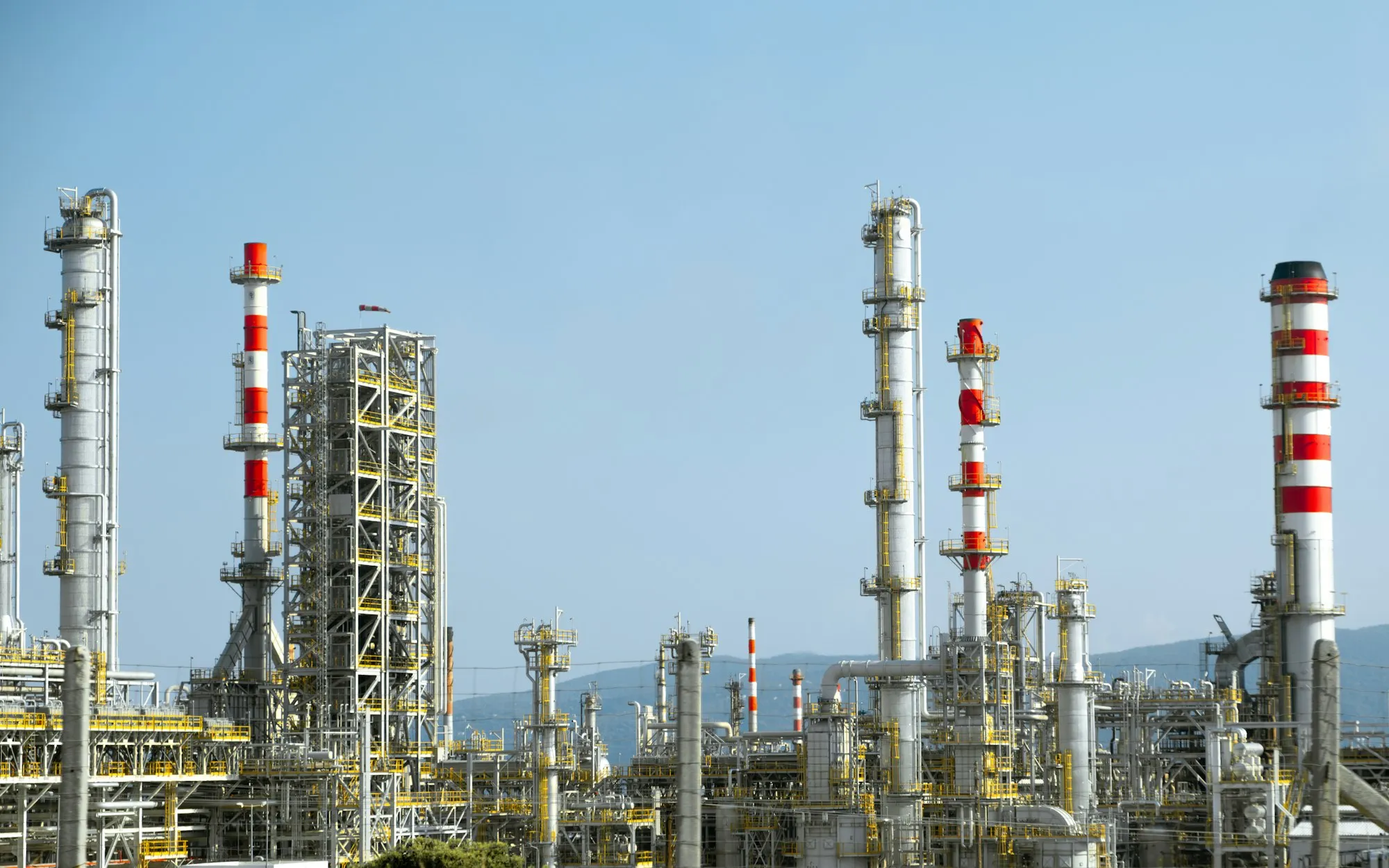 Refinery columns and stacks under a clear blue sky